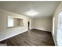 Bright living room with hardwood floors and neutral walls at 4395 Stonewall Tell Rd, College Park, GA 30349