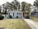 Newly painted gray ranch home with red door and well-manicured lawn at 795 Nw Amber Nw Pl, Atlanta, GA 30331