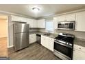 Modern kitchen with stainless steel appliances and white cabinets at 795 Nw Amber Nw Pl, Atlanta, GA 30331