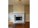 Elegant marble fireplace in living room with hardwood floors at 336 Jasmine Dr, Locust Grove, GA 30248