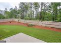 Spacious backyard with wooden fence, landscaping, and patio at 3837 Reece Farm Ct, Powder Springs, GA 30127