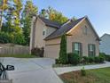 Side view of two-story home showcasing garage and landscaping at 3837 Reece Farm Ct, Powder Springs, GA 30127