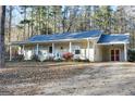 House exterior showcasing a driveway and wooded surroundings at 625 W Richardson St, Oxford, GA 30054