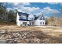 Two-story farmhouse with gray and white siding, landscaping, and a large yard at 1833 Tommy Lee Cook Rd, Palmetto, GA 30268