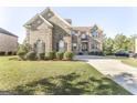 Two story brick home with landscaping and a driveway at 1145 Eagles Brooke Dr, Locust Grove, GA 30248