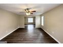 Spacious living room with dark wood-look flooring and ceiling fan at 1091 Cherry Laurel Dr, Lithonia, GA 30058