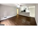 Open living area with hardwood floors, ceiling fan, and a view into the adjacent kitchen at 2830 Battle Forrest Dr, Decatur, GA 30034