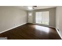 Bright living room featuring hardwood floors, large windows, and a ceiling fan at 2830 Battle Forrest Dr, Decatur, GA 30034
