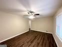 Spacious living room with dark wood-look flooring and ceiling fan at 1581 Mcclelland Ave, Atlanta, GA 30344