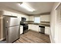 Bright kitchen featuring white shaker cabinets, stainless steel appliances, and wood-look flooring at 2003 Rosewood Rd, Decatur, GA 30032