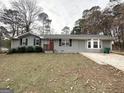 Charming single-story home with a welcoming front porch and a neat lawn at 464 Stonewood Dr, Stone Mountain, GA 30087