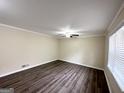 Bright living room with neutral walls, wood-look flooring, and a ceiling fan at 464 Stonewood Dr, Stone Mountain, GA 30087