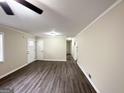 Spacious living room with ample natural light, wood-look flooring, and neutral paint at 464 Stonewood Dr, Stone Mountain, GA 30087