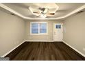 Bright living room with large windows, wood-look flooring, and a ceiling fan at 2353 Arno Ct, Atlanta, GA 30318