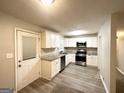 Updated kitchen with white shaker cabinets, stainless steel appliances, and granite countertops at 3429 Adkins Nw Rd, Atlanta, GA 30331