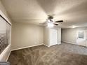 Empty living room with neutral-colored walls, carpet flooring, and ceiling fan at 3429 Adkins Nw Rd, Atlanta, GA 30331