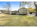 Two-story home with green siding and brick facade, front porch, and attached garage at 735 Willow Bend Dr, Jonesboro, GA 30238