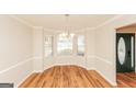 Bright dining area featuring hardwood floors, a bay window, and chair rail molding near the front entrance at 510 Marceau Sw Way, Atlanta, GA 30331