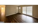 Bright, open living area with wood-look flooring, white walls, and windows with blinds at 1519 Pine Glen Cir, Decatur, GA 30035