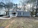 Single-story home with a covered front porch, surrounded by trees at 2556 Godfrey Nw Dr, Atlanta, GA 30318