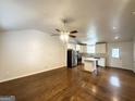 Open-concept living area with hardwood floors, a ceiling fan, and an updated kitchen at 2556 Godfrey Nw Dr, Atlanta, GA 30318