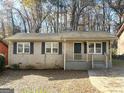Single-Gathering home with a covered porch and driveway at 261 Howell Sw Ter, Atlanta, GA 30331