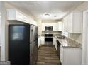 Modern kitchen with white cabinets, granite countertops, and stainless steel appliances at 2843 Marco Nw Dr, Atlanta, GA 30318