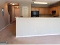 View of the kitchen from the adjacent living area at 5330 Creekview Ln, Morrow, GA 30260