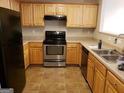 Kitchen with stainless steel appliances and wood cabinets at 5330 Creekview Ln, Morrow, GA 30260