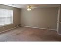 Empty living room with beige carpet and ceiling fan at 5330 Creekview Ln, Morrow, GA 30260