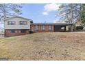 Front view of a two-story home with a grassy yard and mature trees at 3727 Calmer Cir, East Point, GA 30344