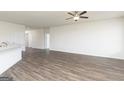 Spacious living room with wood-look flooring, open to the adjacent kitchen at 1025 Claas Way, Locust Grove, GA 30253