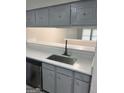 Kitchen pass-through with stainless steel sink and white countertops at 2033 Oak Park Ln, Decatur, GA 30032