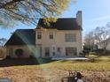 Back of house with patio, landscaping, and a grill at 98 Gleneagles Dr, Fayetteville, GA 30215