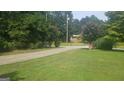 Long driveway leading to a house with a grassy yard at 152 Lakeshore Dr, Stockbridge, GA 30281