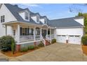 Two-story white house with wraparound porch and two car garage at 3025 Jones Phillips Rd, Dacula, GA 30019