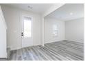 Bright entryway with gray vinyl flooring and a white door at 3402 Arabian Farm Ln, Dacula, GA 30019