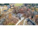 House nestled in wooded neighborhood with long driveway at 240 Edna Ruth Ln, Mcdonough, GA 30253