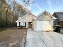 Brick house with a one-car garage and mature trees in the background at 1641 Ne Riverchase Ln, Conyers, GA 30013