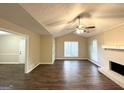 Bright and airy living room with vaulted ceiling and hardwood floors at 1641 Ne Riverchase Ln, Conyers, GA 30013