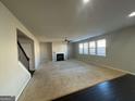 Bright living room with a fireplace and lots of natural light at 566 Mariposa Ln, Mcdonough, GA 30253