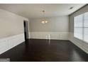 Formal dining room with wainscoting and a chandelier at 566 Mariposa Ln, Mcdonough, GA 30253