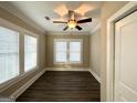 Bright bedroom with hardwood floors and two windows with blinds at 555 Holly Nw St, Atlanta, GA 30318