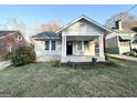 White brick bungalow with a classic design and a nice front yard at 555 Holly Nw St, Atlanta, GA 30318