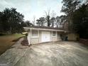 Detached garage with a large driveway and fenced backyard at 1908 Delowe Sw Pl, Atlanta, GA 30311