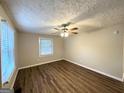 Bright bedroom with wood-look floors and ceiling fan at 3809 Clovis Nw Ct, Atlanta, GA 30331