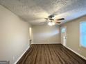 Spacious living room featuring wood-look floors and a ceiling fan at 3809 Clovis Nw Ct, Atlanta, GA 30331