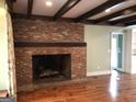 Brick fireplace with wood mantle and hardwood floors at 2095 Sw Flat Shoals Rd, Conyers, GA 30094