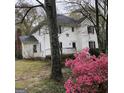 White two-story house with azaleas in front at 2095 Sw Flat Shoals Rd, Conyers, GA 30094