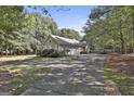 Side view of house showcasing garage and landscaping at 365 Pendleton Trl, Tyrone, GA 30290